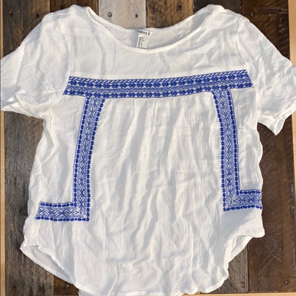 White shirt with blue embroidery